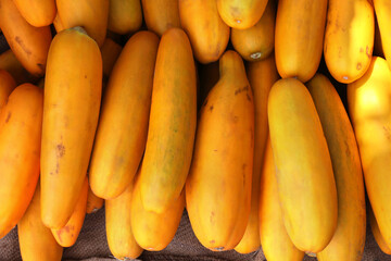 Bunch of fresh yellow cucumbers at market	
