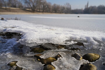 A layer of ice covered the small town lake.