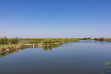 Scenic view of Parco del Delta del Po in Veneto, Italy. Untouched wetlands and nature in Po Delta. Raw wilderness on Via delle Valli Rovigo Province. Large lake in serene unspoiled natural habitat