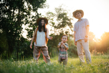 happy harmonious family outdoors concept father and mother and son have activities together on...