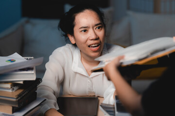 Late-night freelancer, Dedicated Asian woman working overtime on laptop computer, meeting deadlines...