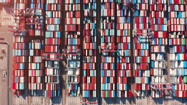 Aerial view container ship carrying container in import export business logistic and transportation. Containers at logistics terminal. 