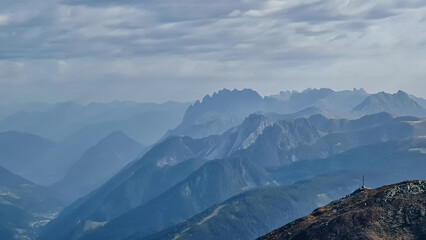 Scenic view from mountain peak Helm (Monte Elmo) in Carnic Alps, South Tyrol, Austria Italy border, Europe. Looking at majestic mountain range of Lienz Dolomites. Hiking on carnic peace trail in Alps