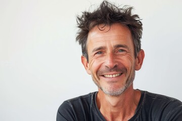 Sunlit portrait of a man with a bright, optimistic expression, white background