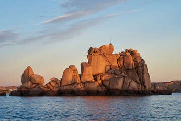great rocky island in Nile river at sunset with cloudy sky in Aswan, Egypt
