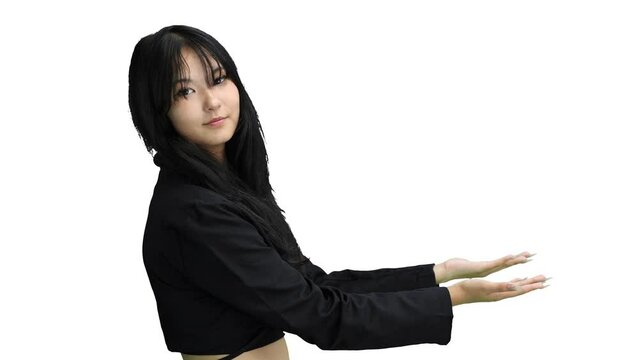 A girl in black clothes, on a white background, points side