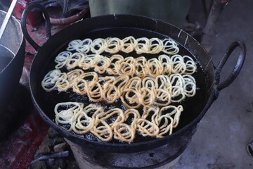 Making Pakistani Famous Street food Jalebi, is a popular sweet snack in south and west Asia, and Mauritius. It goes by many names, including jilapi, zelepi, jilebi, jilipi, zulbia, jerry, jalebi