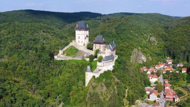 Royal Castle Karlstejn. Central Bohemia, Karlstejn village, Czechia. Aerial view to The Karlstejn castle. Royal palace founded King Charles IV. Amazing gothic monument in Czech Republic, Europe.