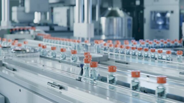 Large Conveyor Belt with Glass Vials inside Modern Pharmaceutical Factory. Medication Manufacturing Process. Medical Ampoule Production Line  
