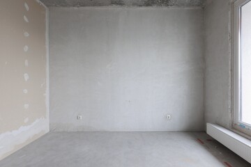 interior of the apartment without decoration in gray colors. rough finish