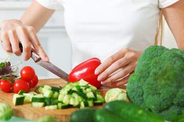 Woman's hands cutting vegetables
