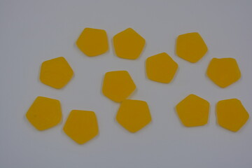Bright and high-quality children's, gummy candies in the form of yellow talismans located on a white background.