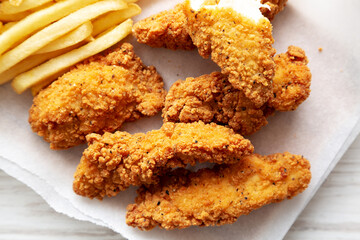 Homemade Chicken Tenders with French Fries, top view. Flat lay, overhead, from above. Close-up.