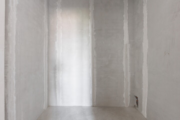 interior of the apartment without decoration in gray colors. rough finish