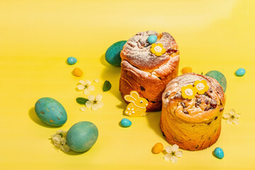 Easter cake Cruffin or sweet bread kulich and traditional painted eggs. Baking and cherry flowers