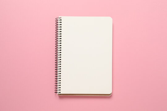 notebook on colored background - Powered by Adobe