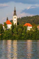Fototapeta na wymiar Beautiful alpine lake Bled - in Slovenia, amazing landscape. View of the lake, island with church, Bled Castle, mountains and blue sky with clouds.