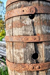 old rusty barrel outside in the grass. 