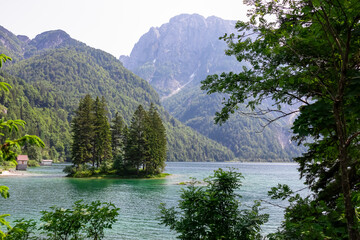 Scenery of Lake Predil with panoramic view of majestic mountain peak Cima del Lago, Tarvisio, Friuli Venezia Giulia, Italy. Tranquil scene in summer. Alpine landscape in Julian Alps, border Slovenia