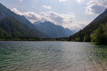 Fototapeta na wymiar Scenery of Lake Predil with panoramic view of majestic mountain peak Cima del Lago, Tarvisio, Friuli Venezia Giulia, Italy. Tranquil scene in summer. Alpine landscape in Julian Alps, border Slovenia