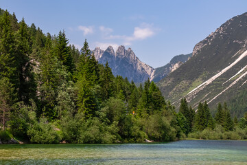 Scenery of Lake Predil with panoramic view of majestic mountain peak Cinque Punte, Tarvisio, Friuli...