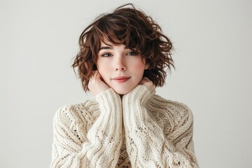 Cozy portrait of a woman in a warm sweater, white background