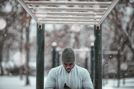 Young Man Exercising Outdoors In Winter Snow