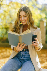 woman reading book in park