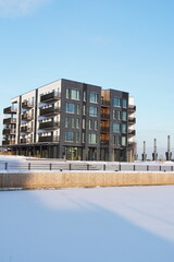 New modern apartments building at Kalamaja district during winter snowy sunny day. Tallinn, Estonia, Europe. January 2024