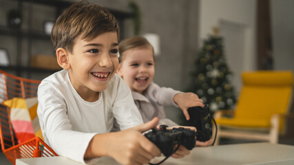 brother and sister siblings boy and girl play video game console © Miljan Živković