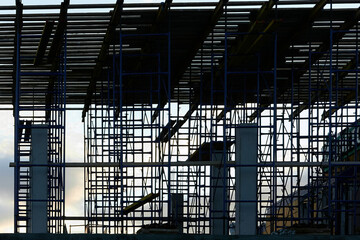silhouette of building concrete structures with rebar against the background of the sunset sky....