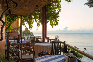 Outdoor cafes and restaurants on the Black sea coast in old town of Nessebar. Sea resort in Bulgaria