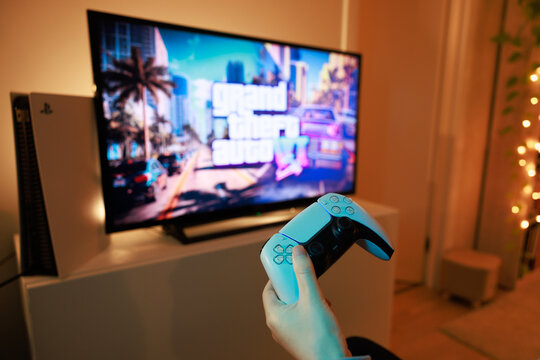 New Grand Theft Auto VI for PlayStation 5. Sony PS5 console. Dualsense controller. Man holding joystick and ready to play upcoming GTA 6 game
