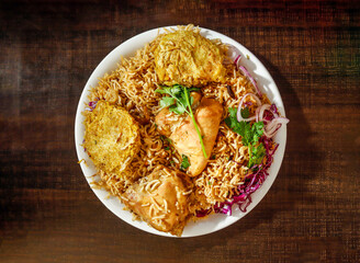 Spicy Chicken pulao with shami kabab onion served in plate isolated wooden background top view...