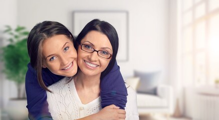 Young loving happy mother hugging teenage daughter