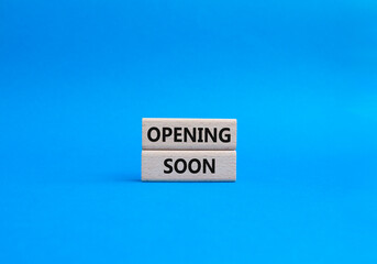 Opening soon symbol. Concept word Opening soon on wooden blocks. Beautiful blue background. Business and Opening soon concept. Copy space