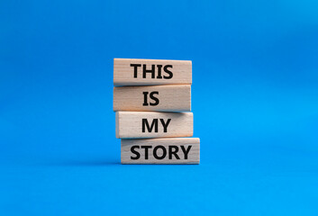 This is my Story symbol. Wooden blocks with words This is my Story. Businessman hand. Beautiful blue background. Business and This is my Story concept. Copy space.