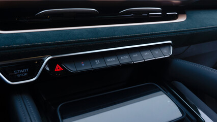 Obraz na płótnie Canvas Emergency stop button on the car dashboard with dark green Alcantara interior trim
