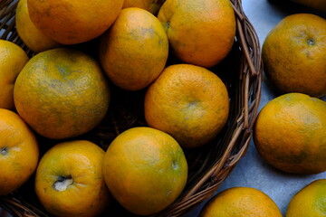 Close up shot of Kinnow Oranges in wooden basket © ravinepz