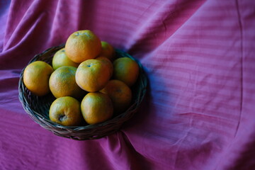 Close up shot of Kinnow Oranges in wooden basket © ravinepz