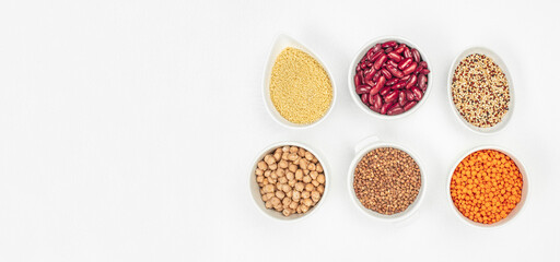 Bowls with different gluten free grains on a white background, Healthy food concept. Long banner format. top view. copy space for text