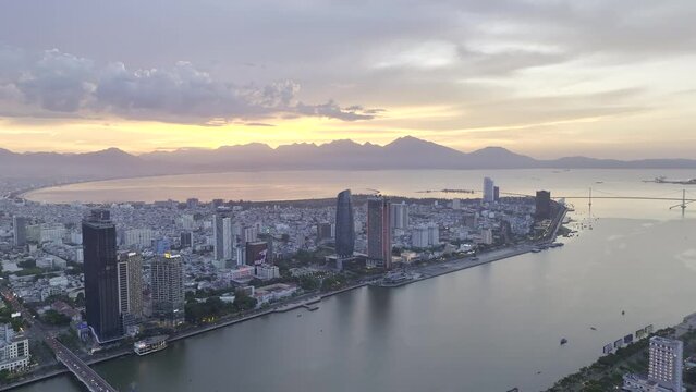 Aerial video of Da Nang, Vietnam city at sunset (HDR ProRes drone footage flying backwards)