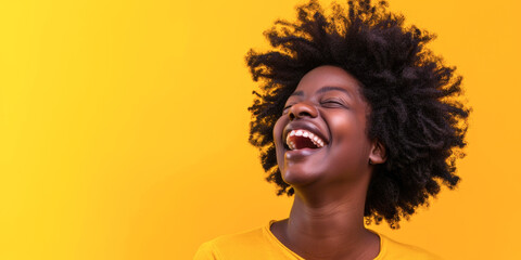 Joyous Black Woman with Afro Hair Laughing Heartily in Yellow Shirt