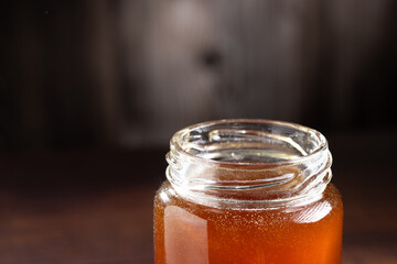 Glass jar of honey. Fresh honey in the jar.