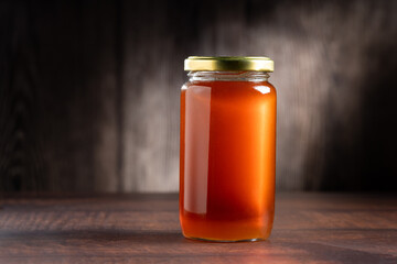 Glass jar of honey. Fresh honey in the jar.
