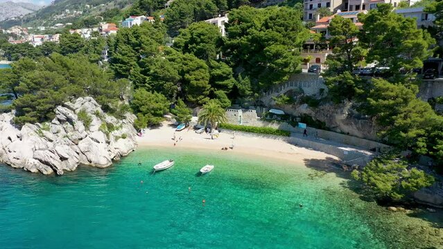 Beautiful Brela on Makarska riviera, Croatia. Adriatic Sea with amazing turquoise clean water and white sand. Aerial view of Brela beach and waterfront on Makarska riviera, Dalmatia region of Croatia.