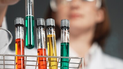 Scientist bring colored solution or chemical liquid doing experiment at laboratory. Teacher bring...