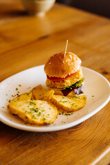 Tasty hamburger with fried sliced potatoes - 705230173