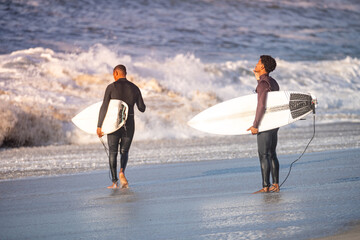 Surfers entering the ocean
