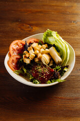 Plate with delicious salad on table - 705237703